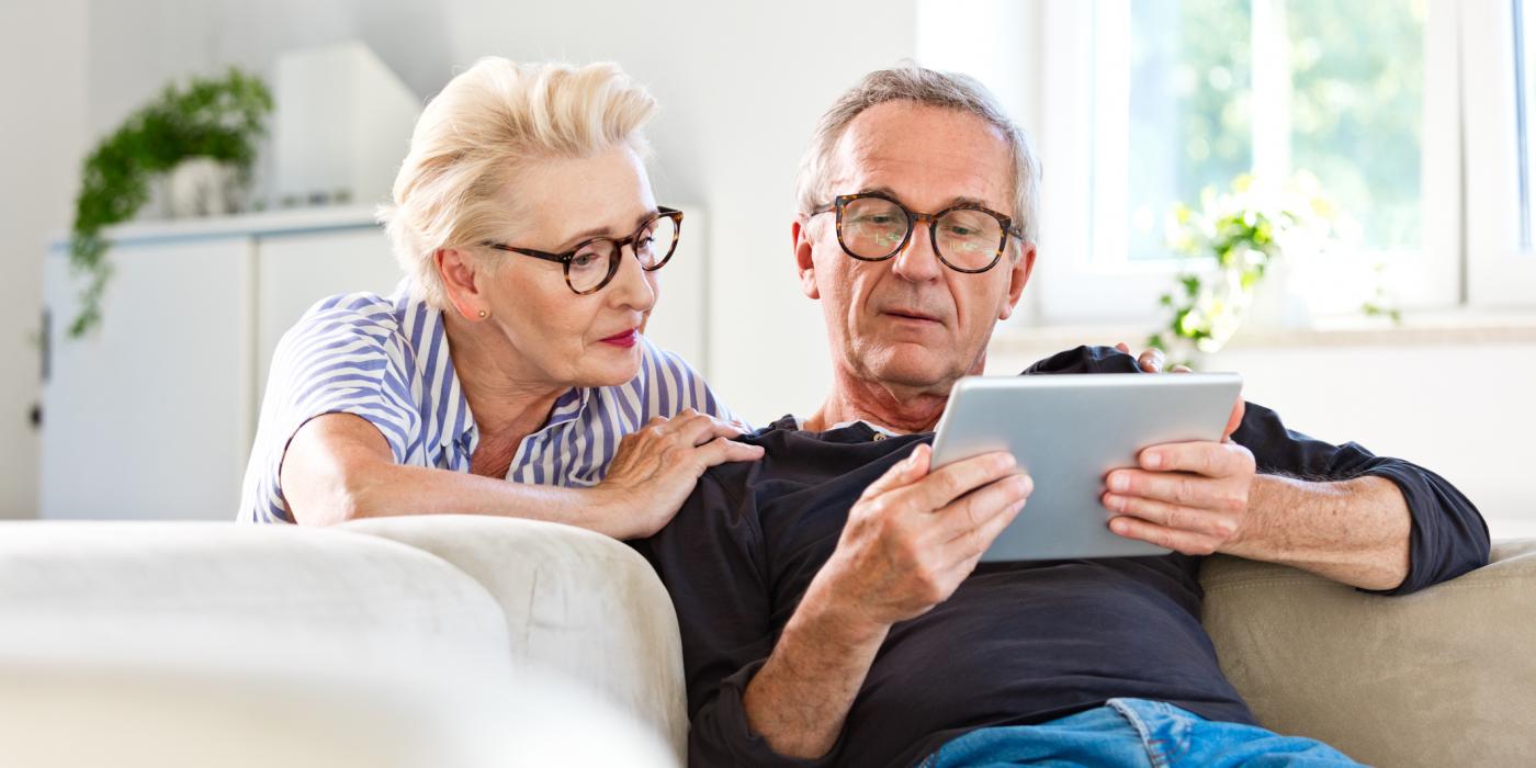 elderly couple view tablet screen
