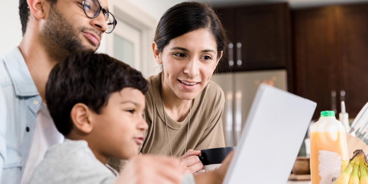 Spanish family gathered around laptop