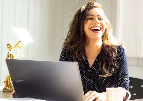Woman smiling and using a computer