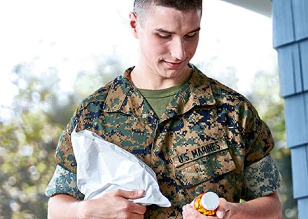 man in uniform getting medication delivery