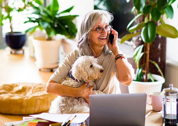woman talking on phone with laptop