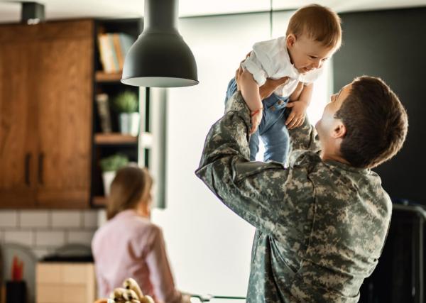 Military Dad hoists baby in kitchen
