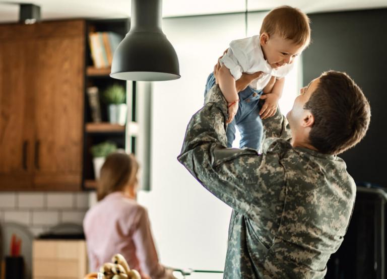 Military Dad hoists baby in kitchen