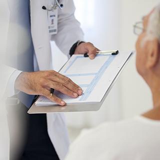 Doctor with chart and patient