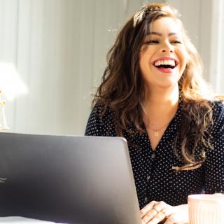 Woman smiling and using a computer