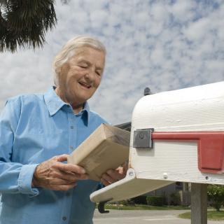 Older man holding a package