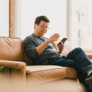 man holding phone and refilling a prescription