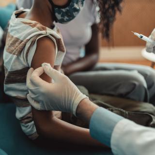 Child receiving vaccine from Pediatrician 