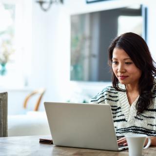 Asian American woman on laptop