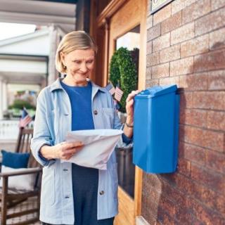 woman holding package outside house