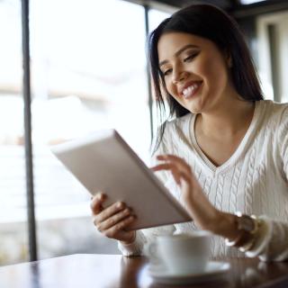 Smiling woman interacting with a tablet